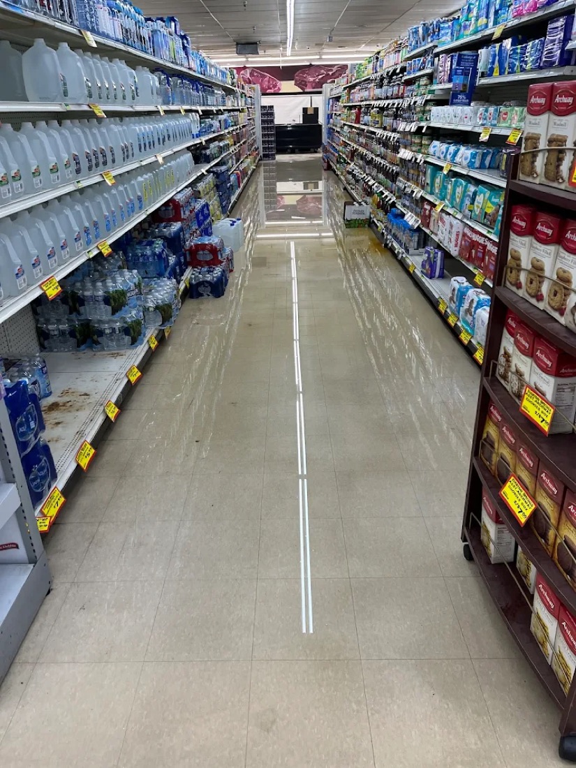 Flooded grocery store aisle during commercial water damage restoration in Metro Detroit