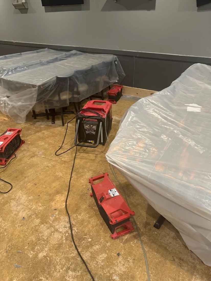 Furniture carefully wrapped in protective plastic during a contents pack-out by Revive Restoration