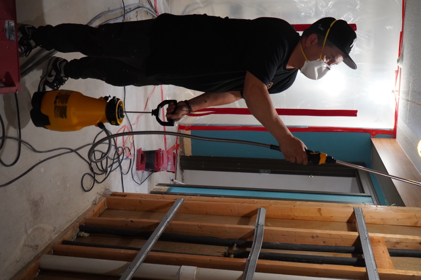 Revive Restoration technician applying antimicrobial treatment during mold remediation in a Michigan home
