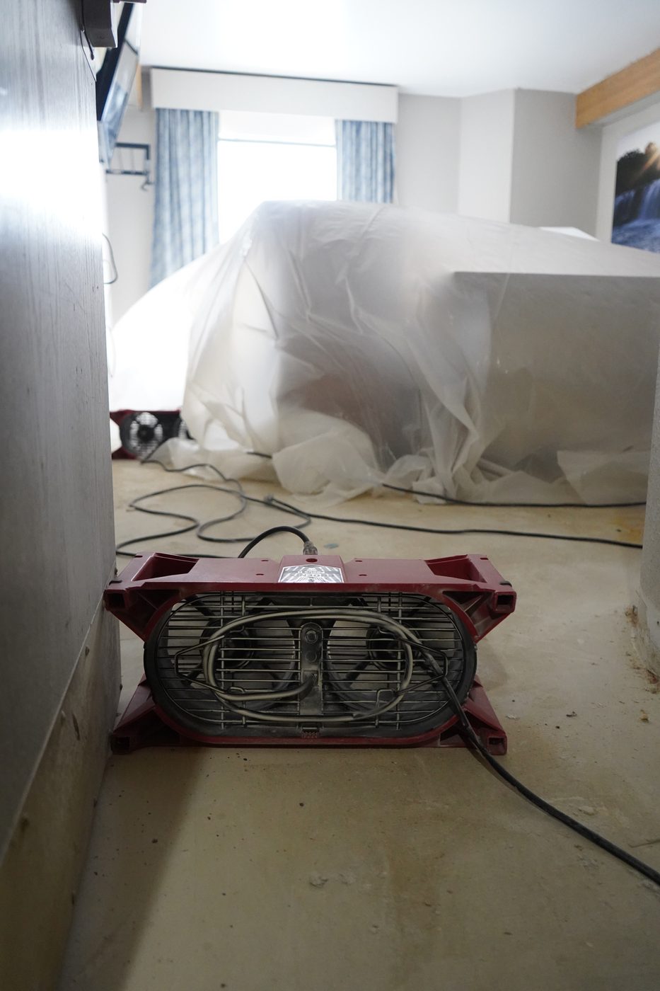 Contents wrapped in plastic sheeting during restoration