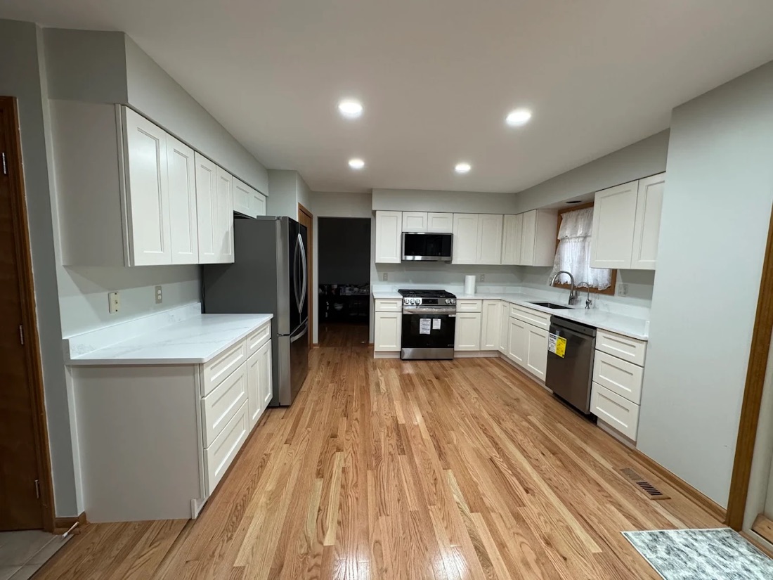 Finished kitchen rebuild by Revive Restoration after water damage, new cabinets, counters and hardwood flooring